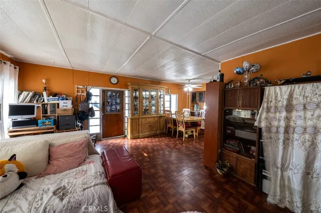 a living room with furniture a flat screen tv and a floor to ceiling window