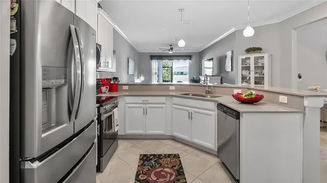 a kitchen with granite countertop a sink stove and cabinets