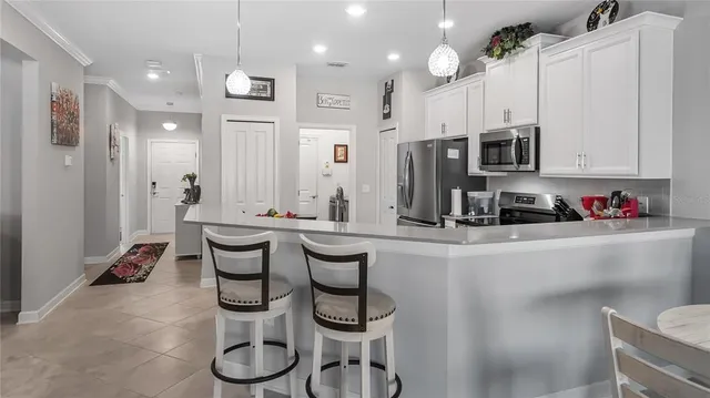 a kitchen with stainless steel appliances granite countertop a refrigerator and a stove top oven