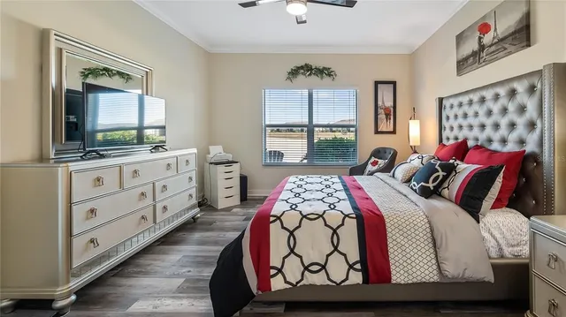 a bedroom with a bed a window and dresser