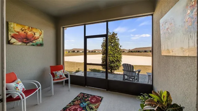 a living room with furniture and a floor to ceiling window