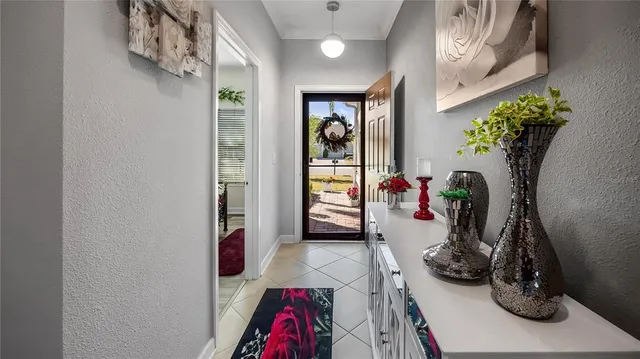 a view of a hallway with wooden floor and a potted plant