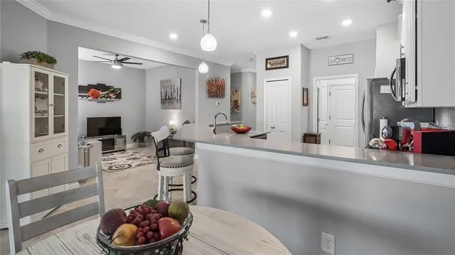 a kitchen with stainless steel appliances kitchen island granite countertop a sink and cabinets