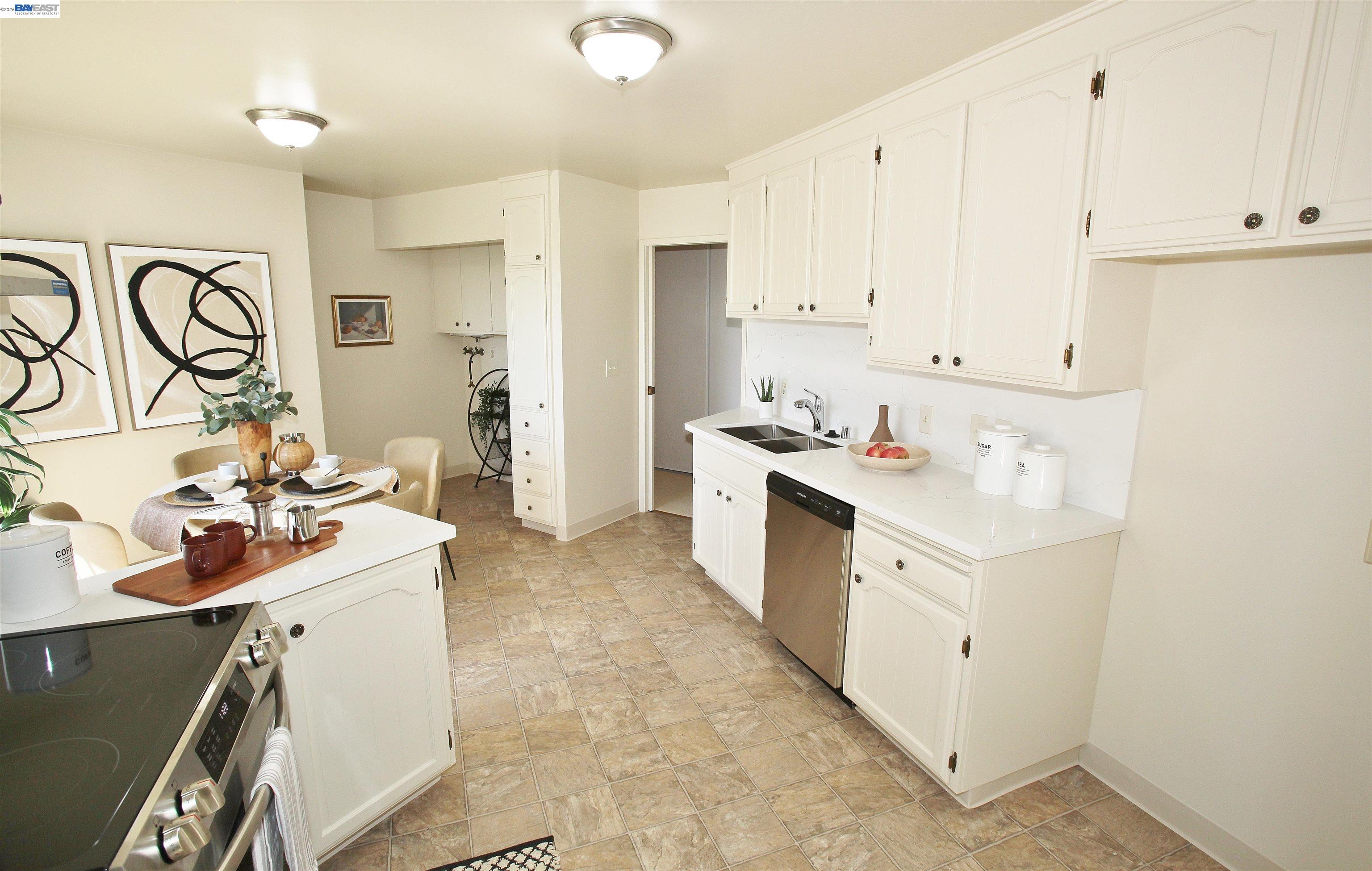 2728 Sheffield Place Castro Valley, CA 94546 - Photo 10 of 29 a kitchen with a sink stove and white cabinets
