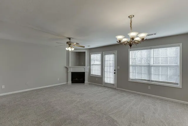 a view of an empty room with a chandelier