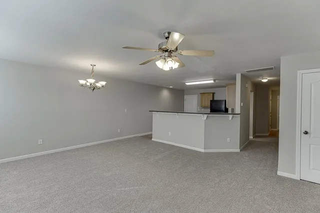 a view of a kitchen with a sink and a refrigerator