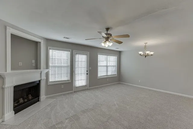 a view of an empty room with a fireplace