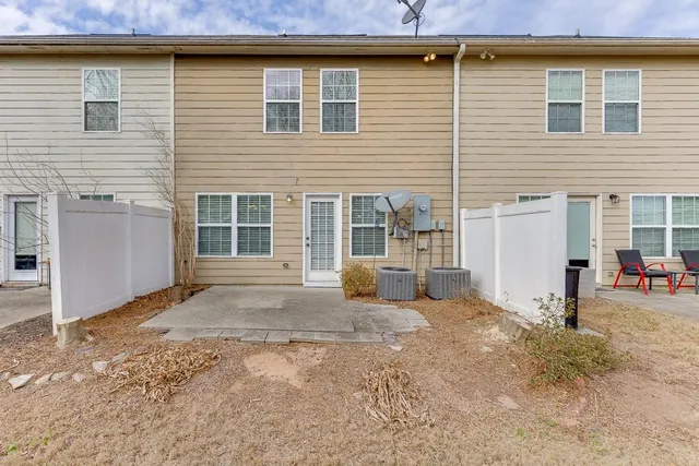 a view of a house with a yard and sitting space