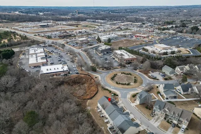 an aerial view of a residential houses with city view
