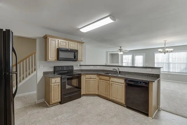 a kitchen with stainless steel appliances granite countertop a stove and a sink