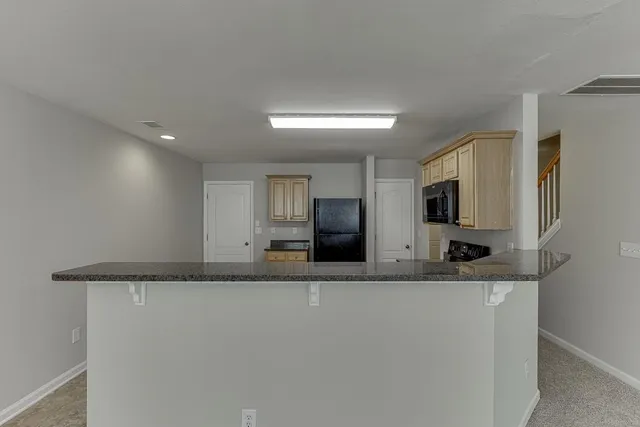 a close view of a sink and a refrigerator in a room