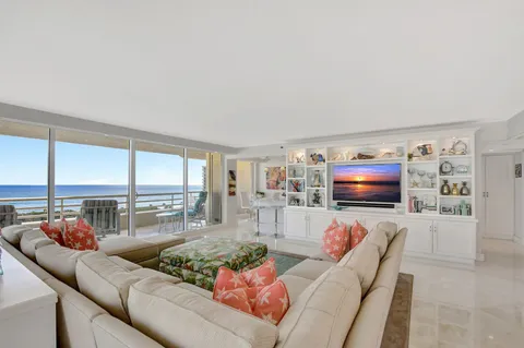 a living room with furniture a large window and a flat screen tv