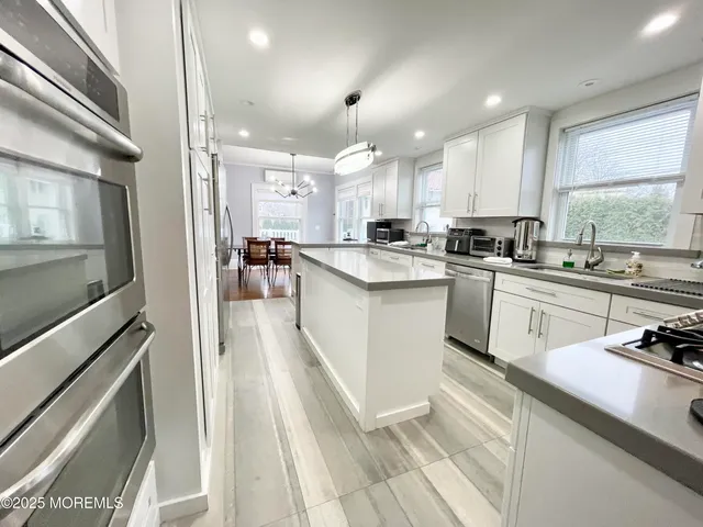 a kitchen with cabinets a sink and appliances
