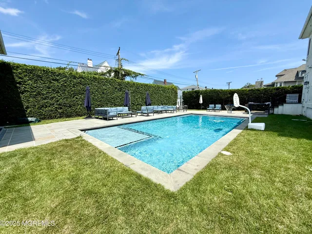 a view of a swimming pool with a yard