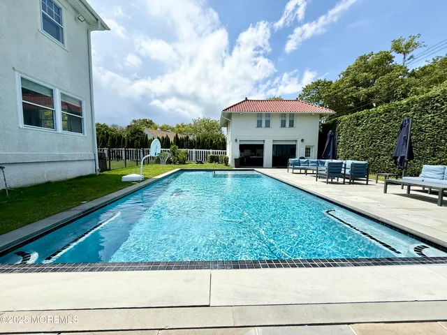 a view of swimming pool with outdoor seating