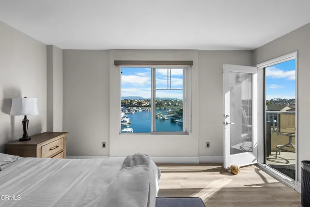 a bedroom with a bed and glass windows