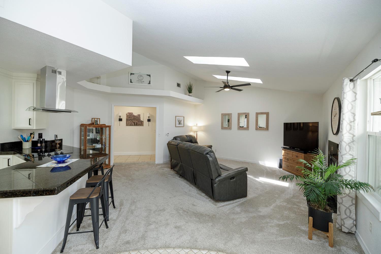 230 Meyenberg Avenue Ripon, CA 95366 - Photo 17 of 52 a living room with furniture and a flat screen tv