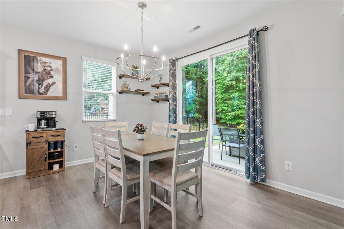 320 Everly Mist Way Wake Forest, NC 27587 - Photo 9 of 34 a view of a dining room with furniture window and wooden floor