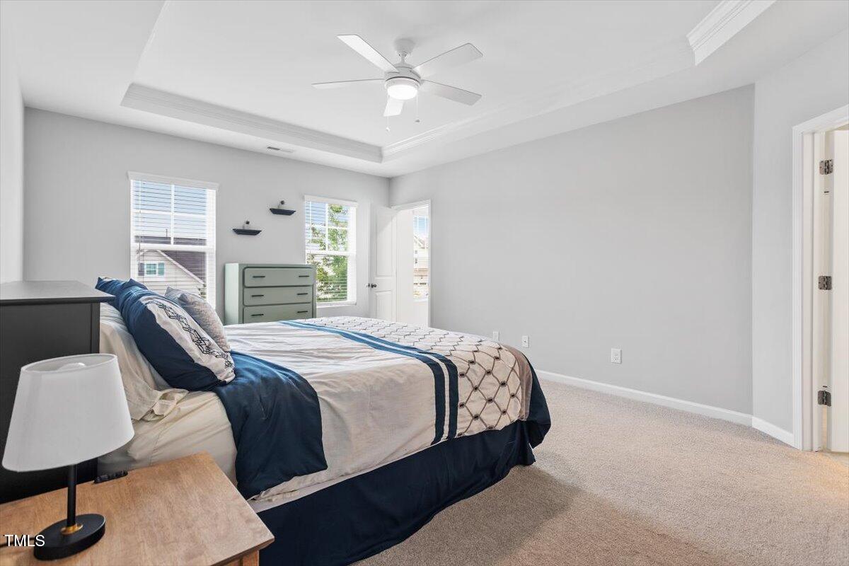 320 Everly Mist Way Wake Forest, NC 27587 - Photo 12 of 34 a bedroom with a bed and a chandelier