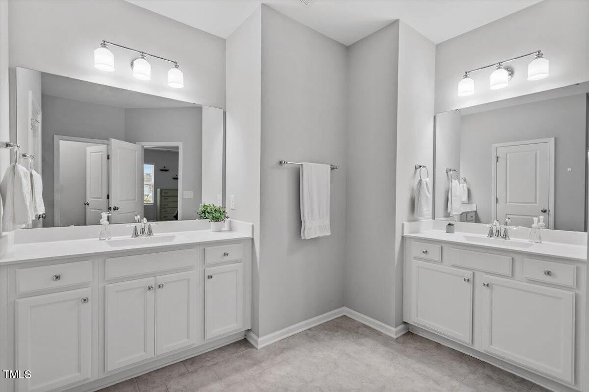320 Everly Mist Way Wake Forest, NC 27587 - Photo 14 of 34 a bathroom with a double vanity sink and mirror