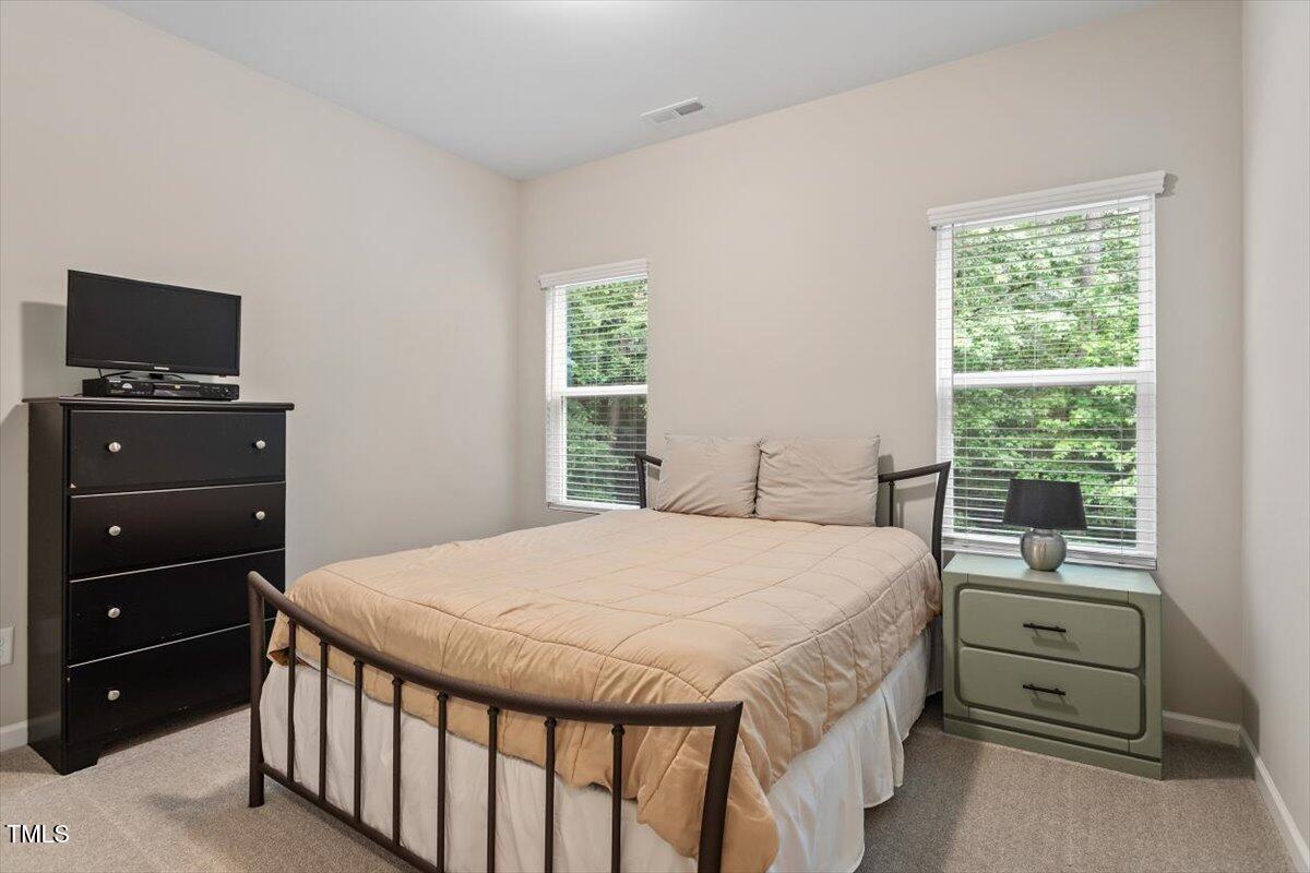 320 Everly Mist Way Wake Forest, NC 27587 - Photo 16 of 34 a bedroom with a bed and a television
