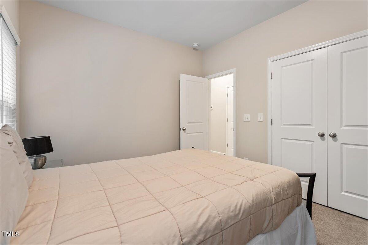 320 Everly Mist Way Wake Forest, NC 27587 - Photo 17 of 34 a bedroom with a bed and a window