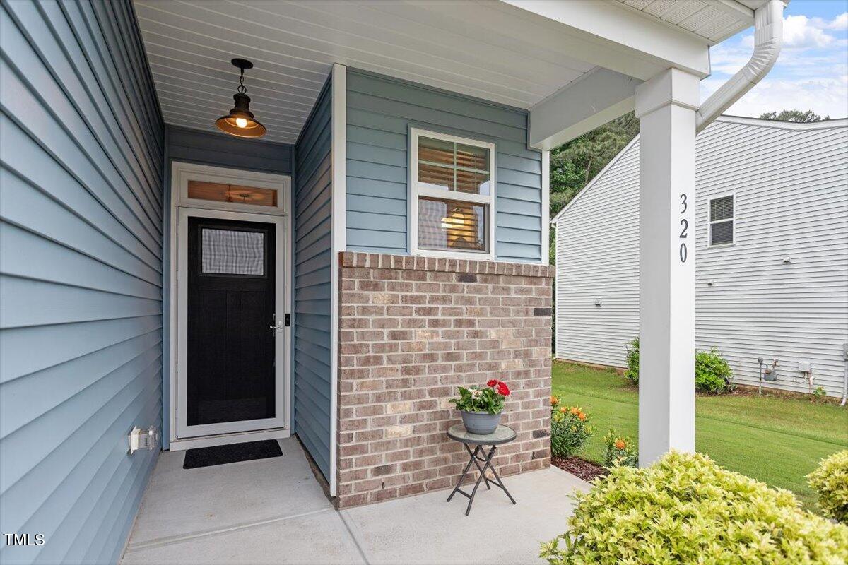 320 Everly Mist Way Wake Forest, NC 27587 - Photo 3 of 34 a front view of a house with a garden