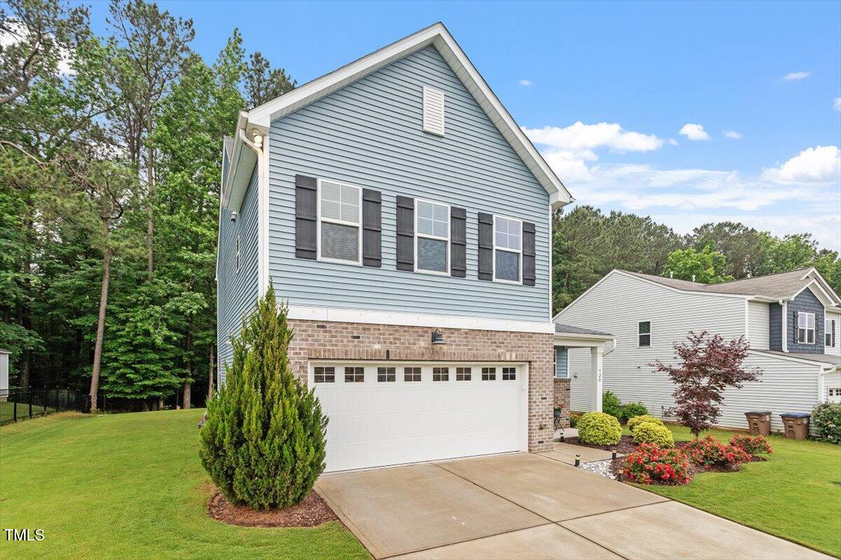 320 Everly Mist Way Wake Forest, NC 27587 - Photo 32 of 34 a front view of a house with garden