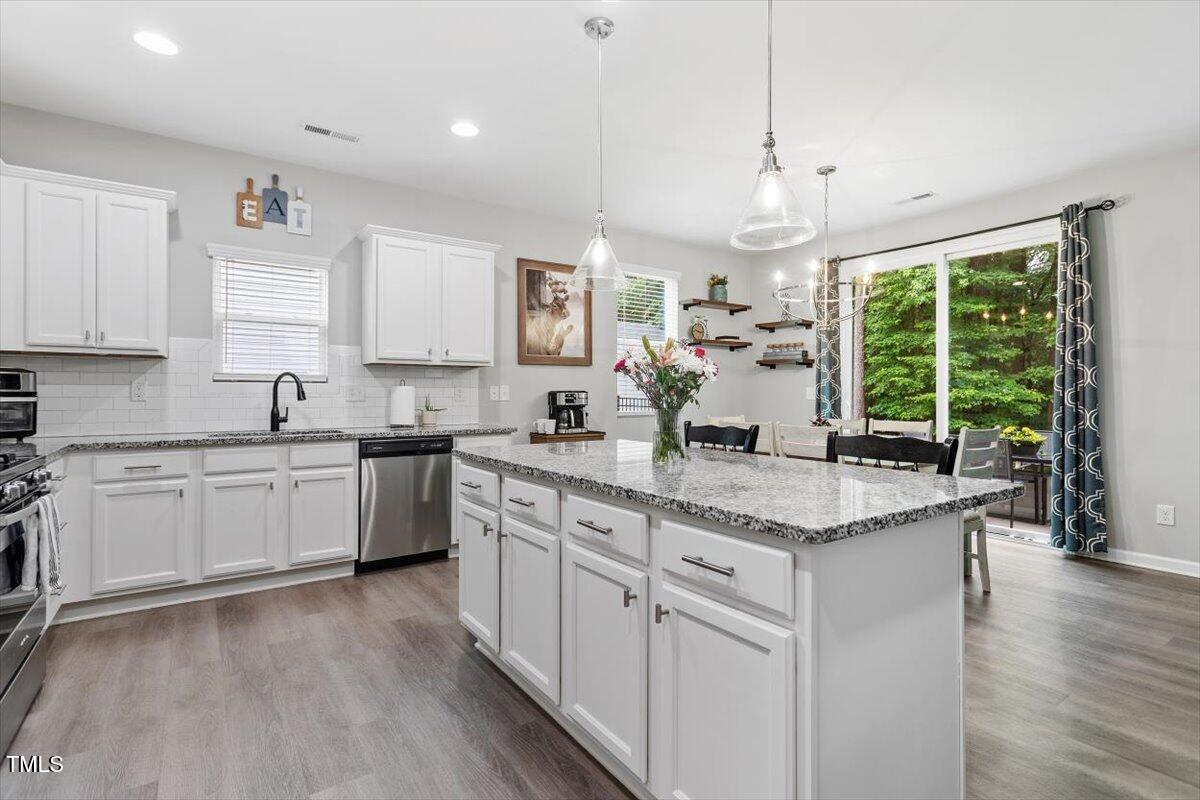 320 Everly Mist Way Wake Forest, NC 27587 - Photo 5 of 34 a kitchen with a sink window and cabinets