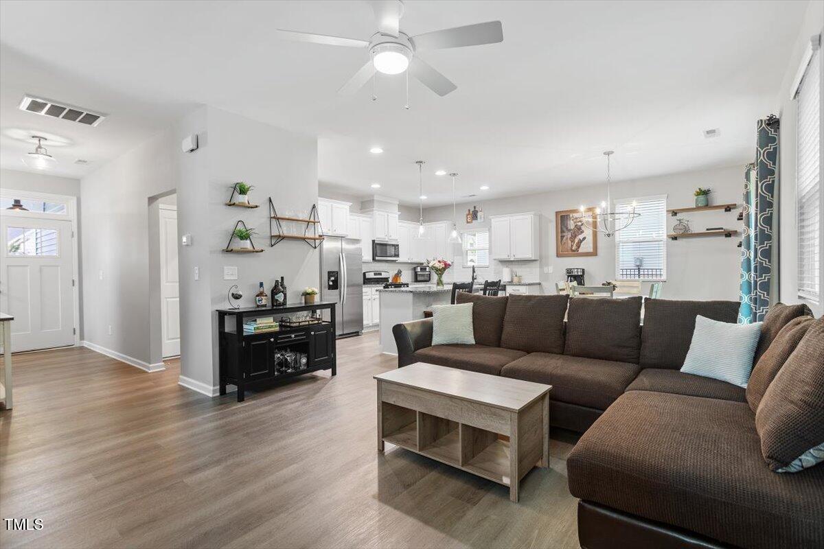 320 Everly Mist Way Wake Forest, NC 27587 - Photo 34 of 34 a living room kitchen with furniture and kitchen view