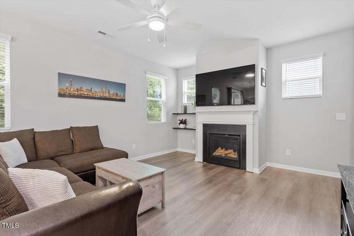 320 Everly Mist Way Wake Forest, NC 27587 - Photo 7 of 34 a living room with furniture a flat screen tv and a fireplace