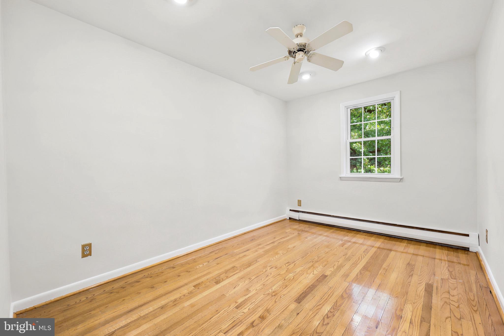 412 Yorkshire Road Bryn Mawr, PA 19010 - Photo 14 of 25 an empty room with a window and a ceiling fan