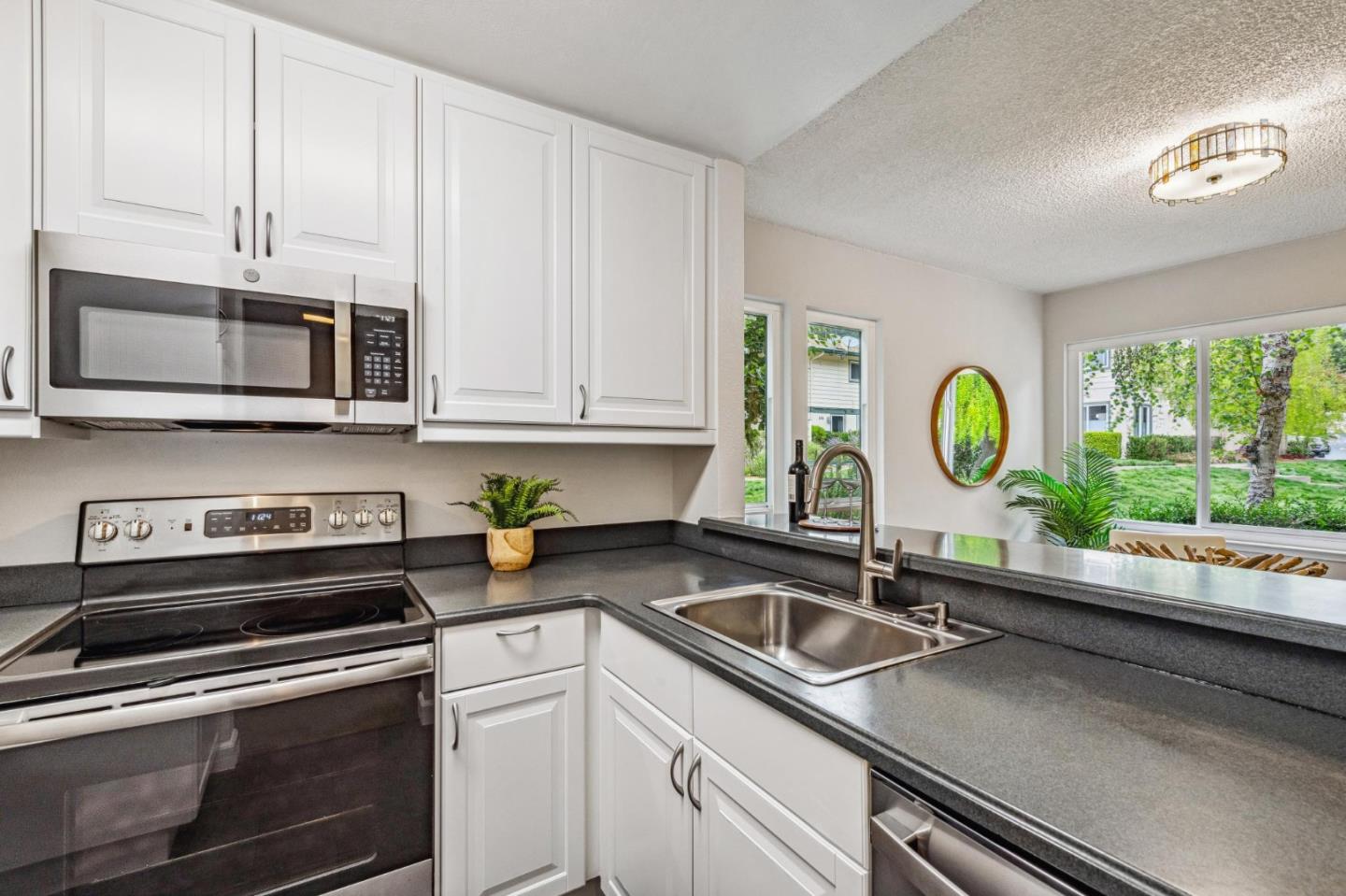 1337 Terra Nova Boulevard Pacifica, CA 94044 - Photo 6 of 21 a kitchen with stainless steel appliances granite countertop a sink a stove and microwave