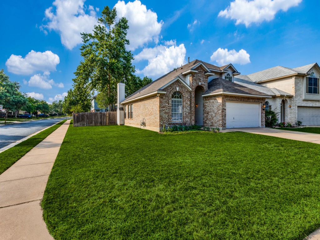 a front view of house with yard and green space