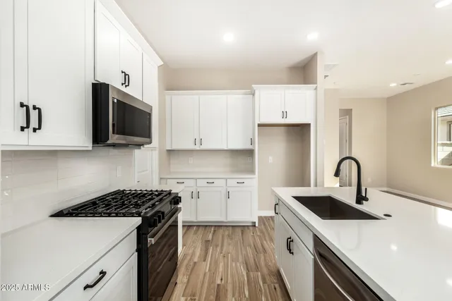 a kitchen that has a sink and a stove in it