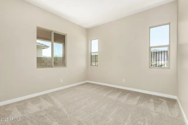 an empty room with windows and bathroom