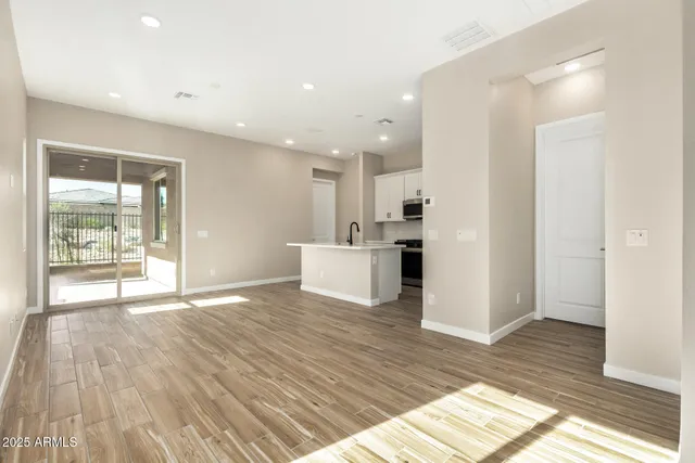a view of kitchen with refrigerator microwave and stove top oven