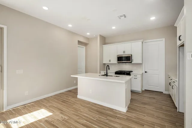 a view of a kitchen with a sink stove and refrigerator