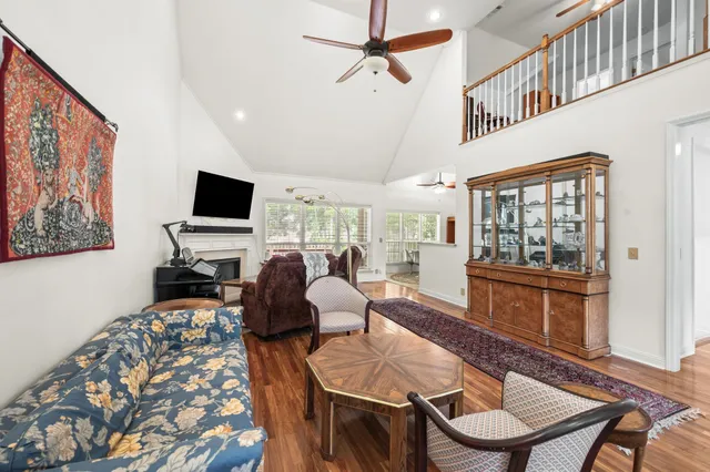 a living room with furniture a flat screen tv and a window