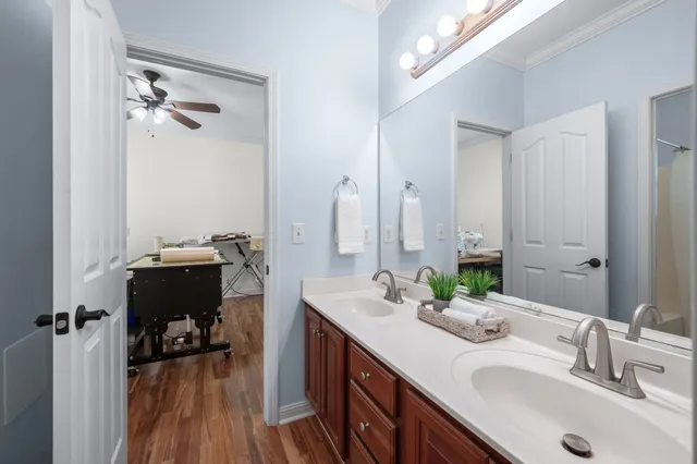 a spacious bathroom with a double vanity sink a mirror and a shower
