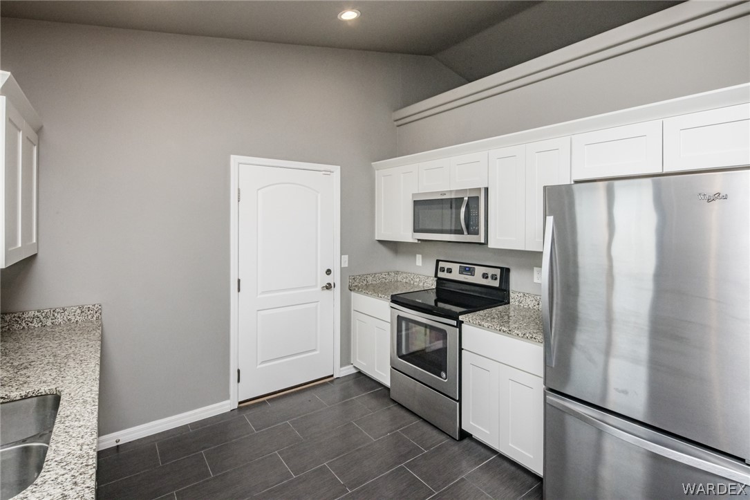 3621 North Kenneth Road Kingman, AZ 86409 - Photo 21 of 47 a kitchen with a refrigerator stove and microwave