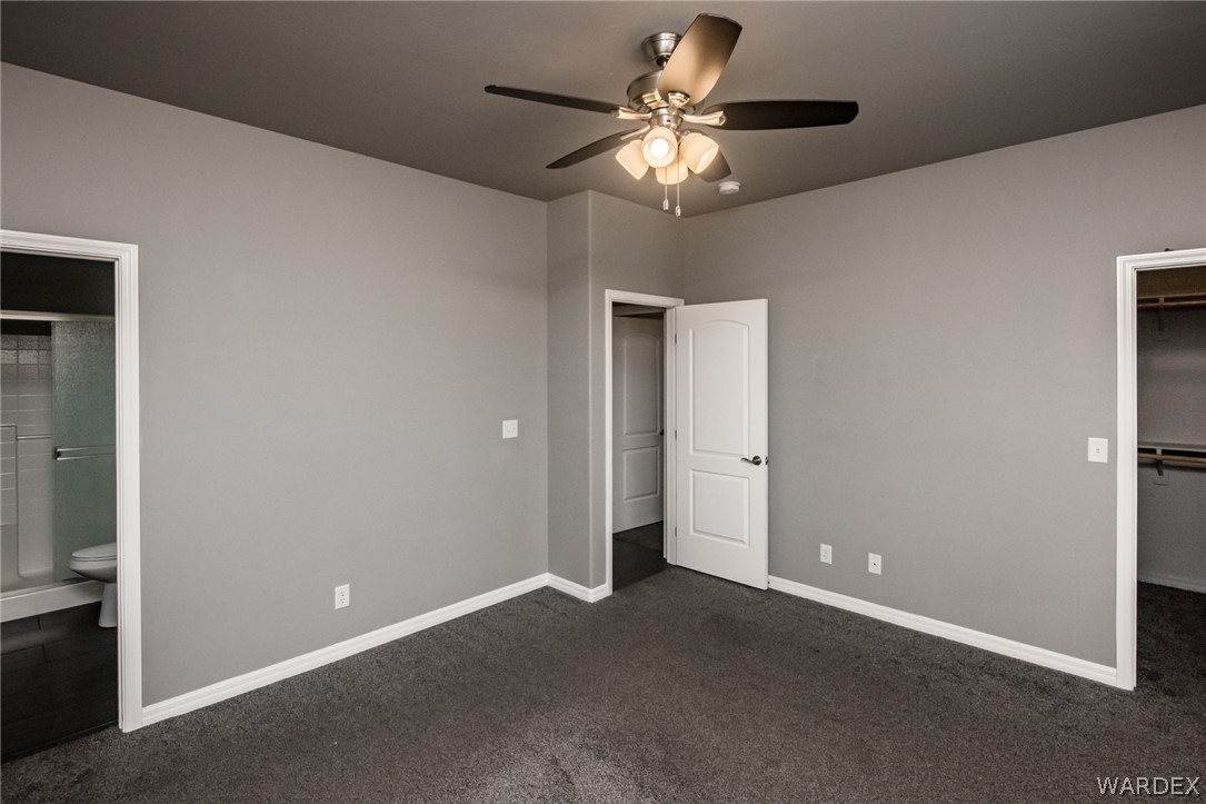 3621 North Kenneth Road Kingman, AZ 86409 - Photo 26 of 47 a view of an empty room with a chandelier fan