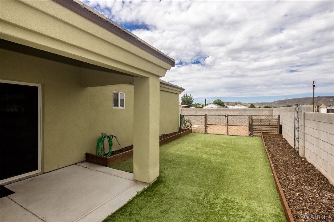 3621 North Kenneth Road Kingman, AZ 86409 - Photo 42 of 47 a view of a backyard with plants and brick wall