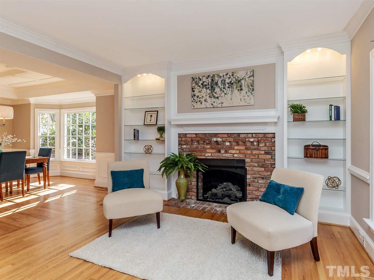 405 Bridgetender Drive Raleigh, NC 27615 - Photo 3 of 24 Built in bookcases flank gas fireplace in a comfortable living room.