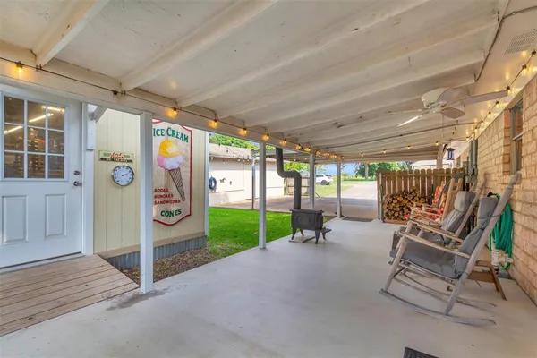 a view of a patio with table and chairs a barbeque with wooden fence