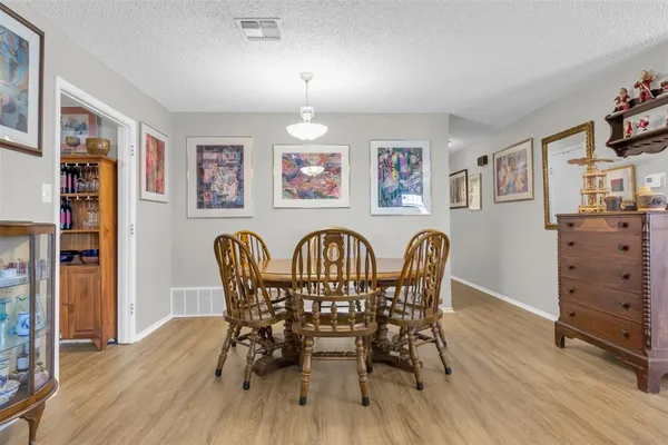 a view of a dining room with furniture wooden floor and window