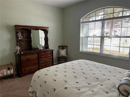 a kitchen with a dining table chairs and microwave