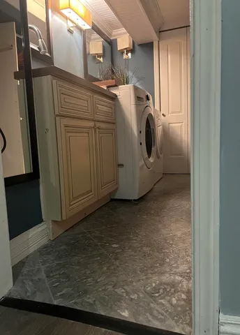 a view of an empty room with an empty space and a window