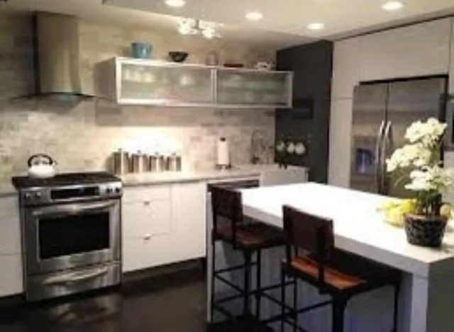 a kitchen with a sink cabinets and stainless steel appliances
