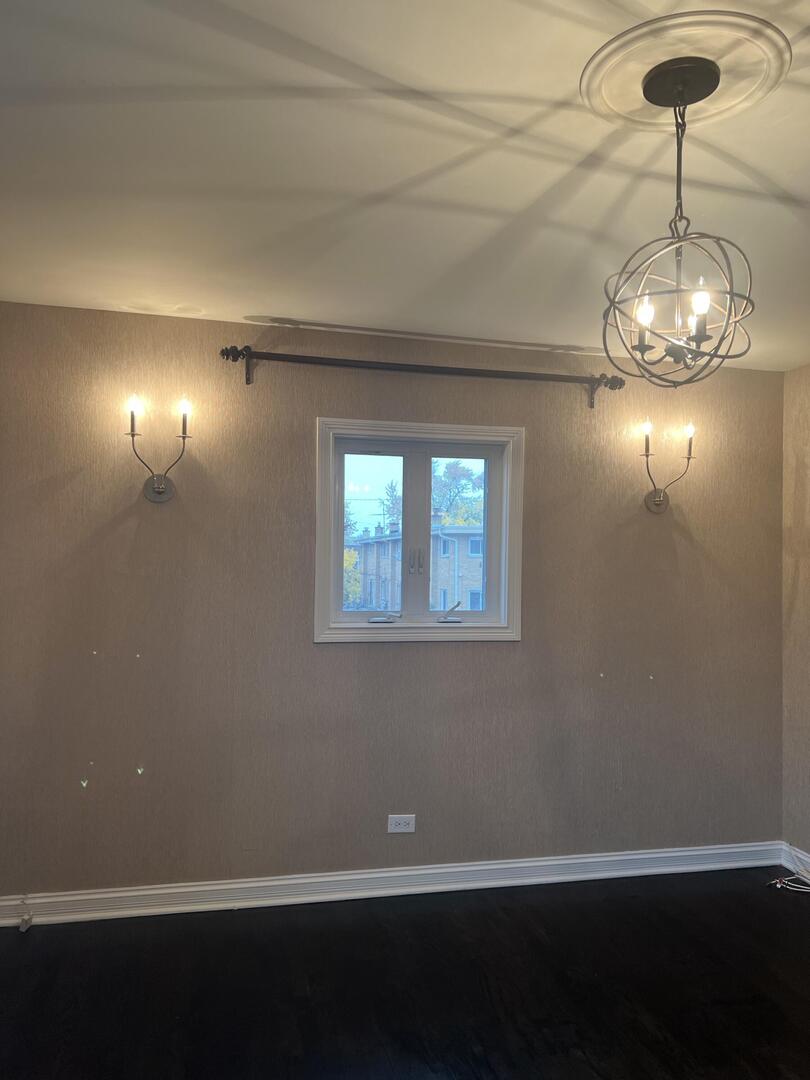 9121 Niles Center Road, Unit 2W Skokie, IL 60076 - Photo 9 of 12 a view of empty room with wooden floor